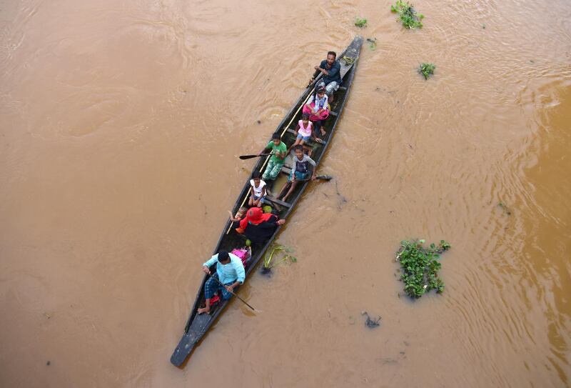 Flood-affected villagers are transported on a boat to a safer place at Kachua village in Nagaon district, in the northeastern state of Assam, India. Reuters