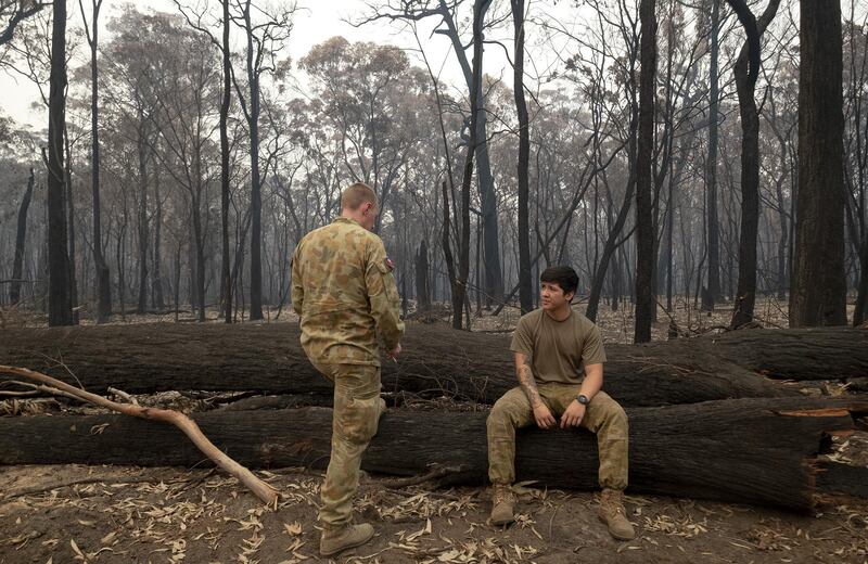 Australian Defence Force (ADF) personnel take a break after arriving in Mallacoota. Getty Images