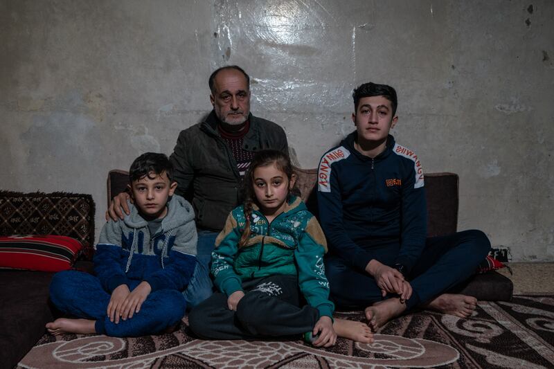 Muhammad, Alaa and Mustafa, with their father, Mudathir Al Ghanam, in their Azmarin home. ‘I have suffered a lot, as I lost one of my sons and my brother,’ said Mr Al Ghanam. He said his children had undergone many operations ’but they have benefitted greatly from the services of this centre’