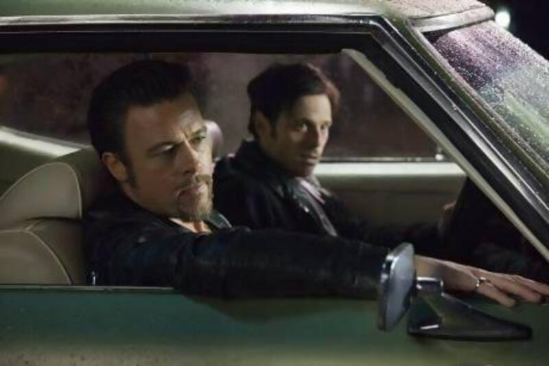 Brad Pitt, left, plays the hit-man Jackie Cogan while Scoot McNairy is an inept hustler in Killing Them Softly. Melinda Sue Gordon / Cogan's Productions