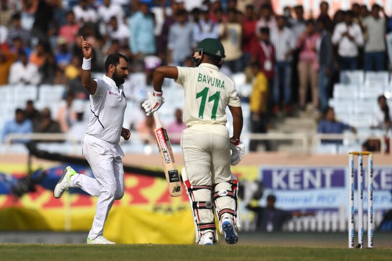 India bowler Mohammed Shami, left, celebrates after taking the wicket of South Africa's Temba Bavuma. AFP