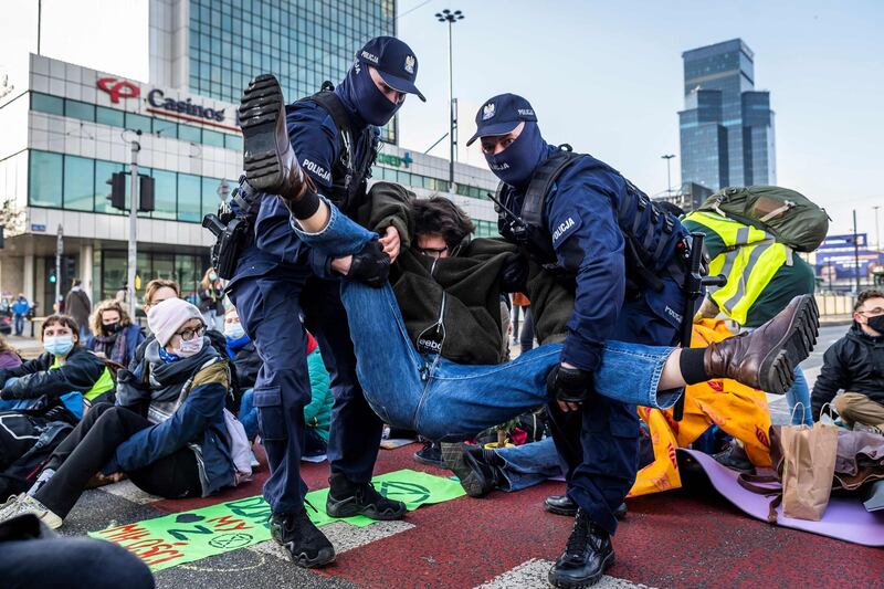 Polish police remove Extinction Rebellion environmental activists from during a sit-down protest in central Warsaw. The event was to draw public attention to the climate crisis. AFP