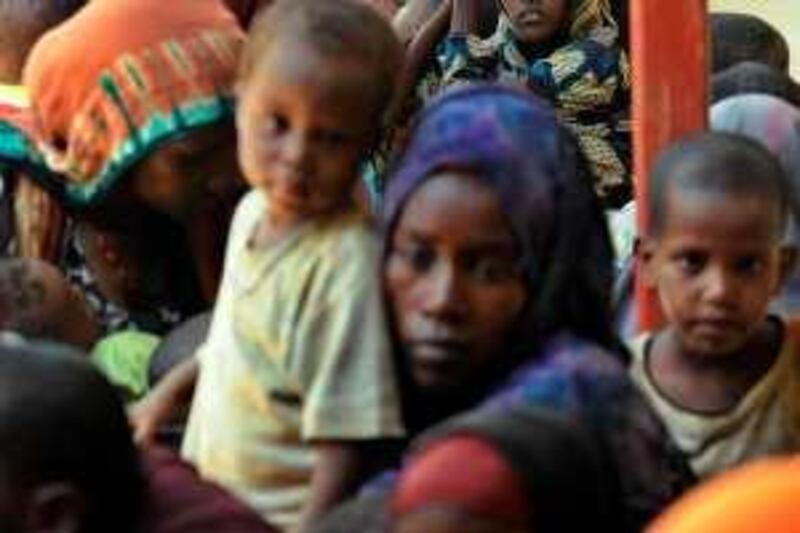 (FILES) A file photo taken on October 16, 2008 shows newly arrived Somali refugees gathering at a registration center at the Dadaab camp in northeastern Kenya, where Somalis fleeing violence in their capital, Mogadishu, continued to flock. Kenyan officials have deported hundreds of Somalis fleeing violence, demanded bribes through threats and sexual violence and forced back those unable to pay, a human rights group said on March 30, 2009. The refugees' plight has been aggravated by the 2007 closure of the Kenya-Somalia border as authorities turn a blind eye to police corruption and abuses at the frontier, the Human Rights Watch said in a report.          AFP PHOTO/Tony  KARUMBA