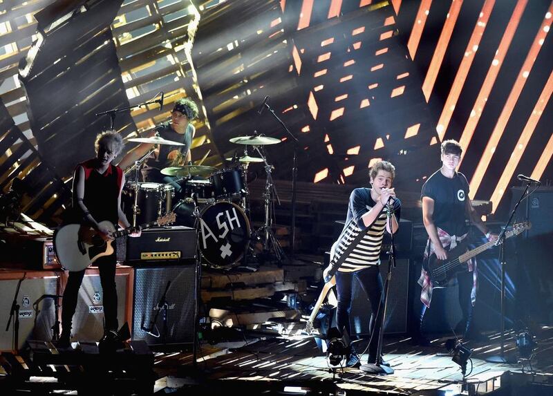 From left to right: Recording artists Michael Clifford, Ashton Irwin, Luke Hemmings, and Calum Hood of 5 Seconds of Summer perform onstage during the 2014 MTV Video Music Awards at The Forum. Michael Buckner / Getty Images / AFP