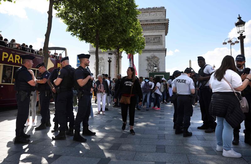 French police stand guard at the Champs Elysees avenue near the Arc de Triomphe in Paris ahead of the Champions League final between Liverpool and Real Madrid. AFP