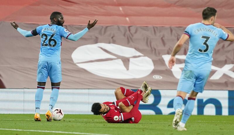 Liverpool attacker Mohamed Salah goes down in the area after a challenge by West Ham's Arthur Masuaku that led to the penalty. Reuters