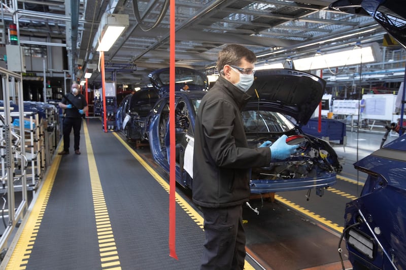 Members of staff working between two-metre wide designated work stations on a car assembly line at the Vauxhall car factory during preparedness tests and redesign ahead of re-opening following the COVID-19 outbreak. Located in Ellesmere Port, Wirral, the factory opened in 1962 and currently employs around 1100 workers. It ceased production on 17 March 2020 and will only resume work upon the advice of the UK Government, which will involve stringent physical distancing measures being in place across the site. (Photo by Colin McPherson/Corbis via Getty Images)