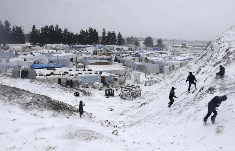 Syrian refugees play with snow during a winter storm in Zahle, in the Bekaa Valley in Lebanon. Reuters