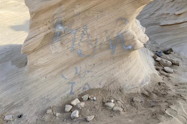 Spray-painted graffiti daubed on one of the rock formations at the Fossil Dunes site. Courtesy: Hannah Androulaki-Khan