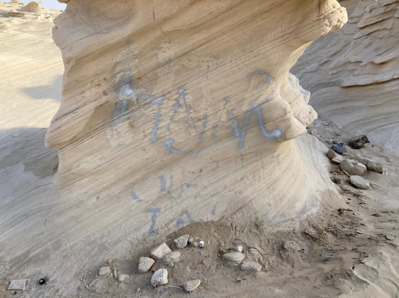 Spray-painted graffiti daubed on one of the rock formations at the Fossil Dunes site. The new law allows the Environment Agency Abu Dhabi to take action against  graffiti. Photo: Hannah Androulaki-Khan