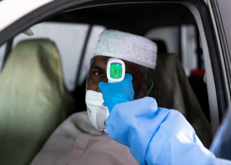 Ras Al Khaimah, UNITED ARAB EMIRATES. 30 APRIL 2020. 
A nurse checks the temperature of a police officer at the SEHA’s Ras Al Khaimah Covid-19 drive-through testing centre.
(Photo: Reem Mohammed/The National)

Reporter:
Section: