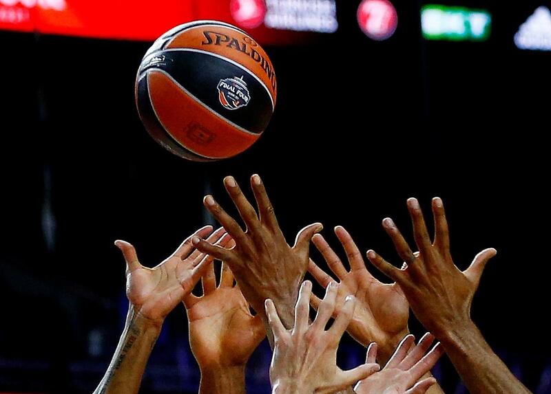 Players reach for the ball during basketball's EuroLeague Final Four match between FC Barcelona v Olimpia Milano at the Lanxess Arena in Cologne, Germany, on Friday May 28. Reuters