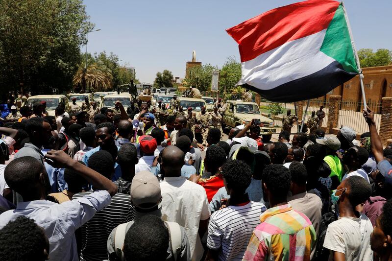 FILE PHOTO: Sudanese demonstrators chant slogans in front of security forces during a protest in Khartoum, Sudan April 15, 2019. REUTERS/Umit Bektas/File Photo