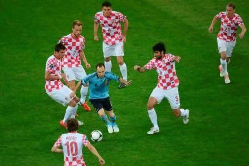 Even six Croatian players were able to do little to slow Spanish midfielder Andres Iniesta, centre, though Spain only scored once, thanks to Jesus Navas.