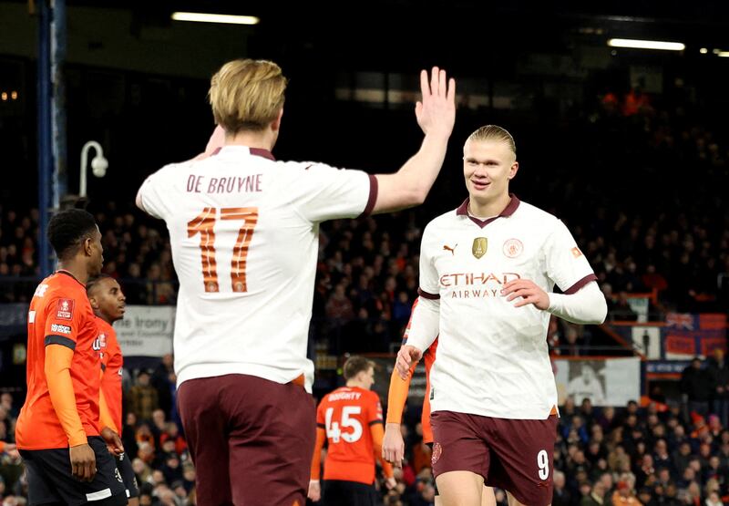 Manchester City's Erling Haaland, right, celebrates scoring the first goal of his five goals against Luton Town with teammate Kevin De Bruyne. Reuters