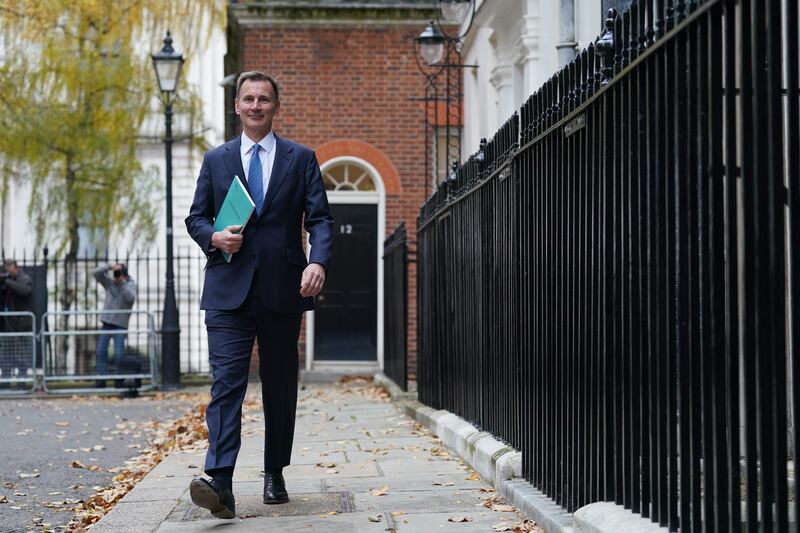 Mr Hunt leaves No 11 Downing Street for the House of Commons to deliver his budget. PA