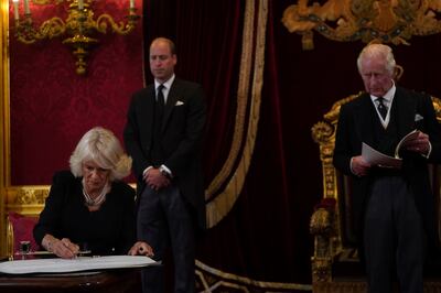 Queen Consort Camilla signs the oath to uphold the security of the Church of Scotland during the Accession Council ceremony at St James's Palace where her husband was declared king of Britain. AP
