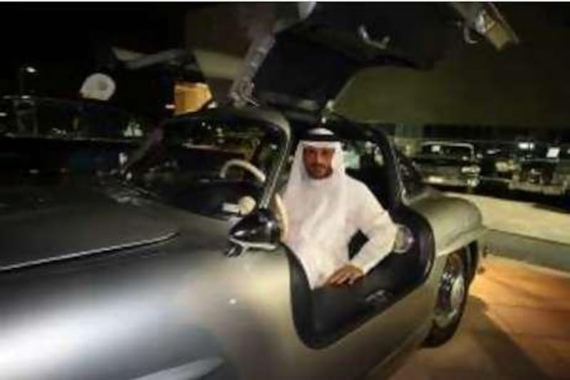 DUBAI, UNITED ARAB EMIRATES - DECEMBER 2:  Mohammed Bin Sulayem with a 1956 Mercedes 300 SL, one of his twenty cars on display at a car exhibit which was held at Dubai Festival City in Dubai on December 2, 2008.  (Randi Sokoloff / The National)  For story by Nour Samaha. *** Local Caption ***  RS004-1202-CARS.jpg