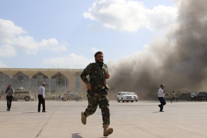 FILE PHOTO: A security personnel and people react during an attack on Aden airport moments after a plane landed carrying a newly formed cabinet for government-held parts of Yemen, in Aden, Yemen December 30, 2020. REUTERS/Fawaz Salman/File Photo