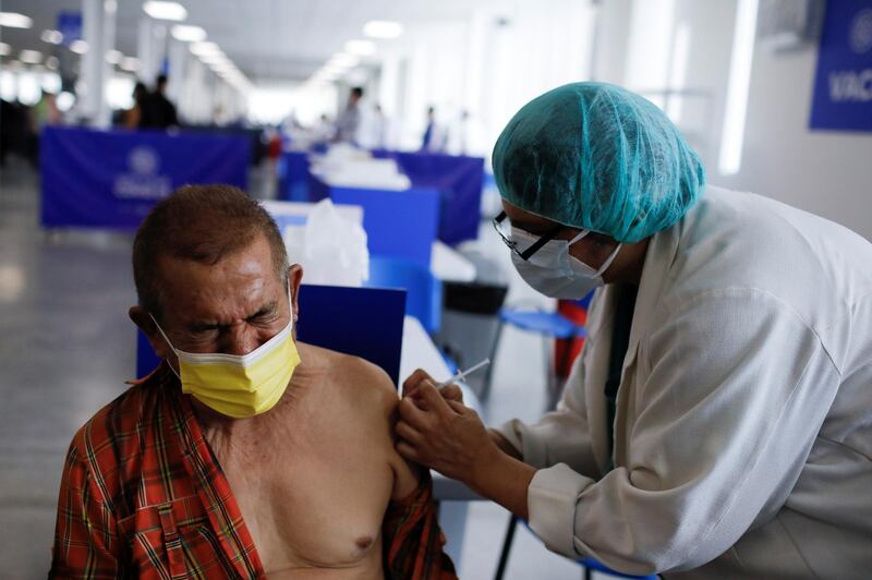 A health worker administers a dose of Sinovac's CoronaVac vaccine at an inoculation centre in San Salvador, El Salvador. Reuters