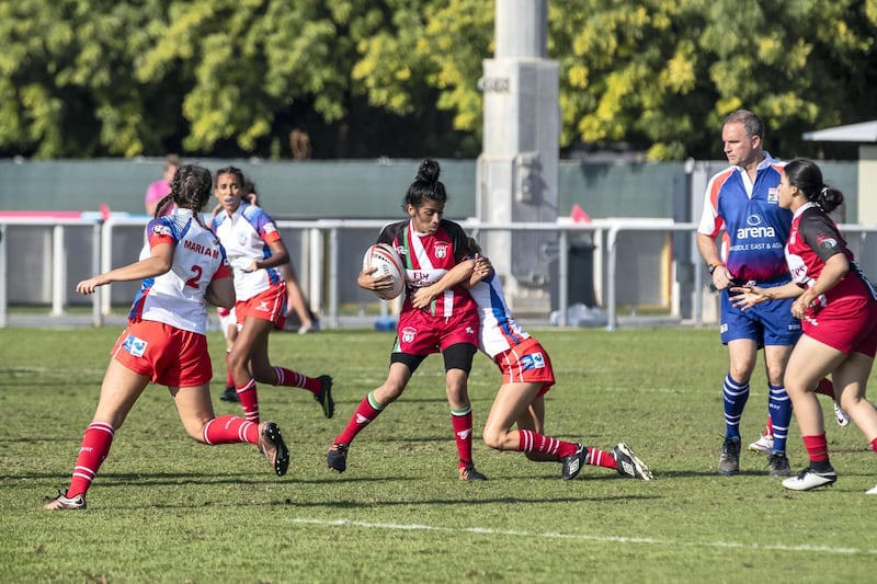 ABU DHABI, UNITED ARAB EMIRATES. 29 November 2018. First day of the Rugby Sevens Tournament. Al Maha School girls team of all Emirati Female Players (Red and black colours). (Photo: Antonie Robertson/The National) Journalist: Paul Radley. Section: Sport.