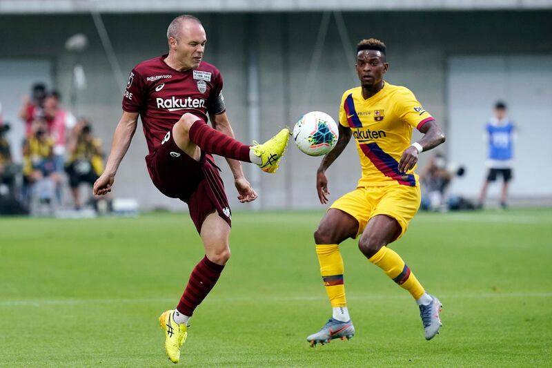 Vissel Kobe's Andres Iniesta, left, is challenged by Nelson Semedo. AP Photo