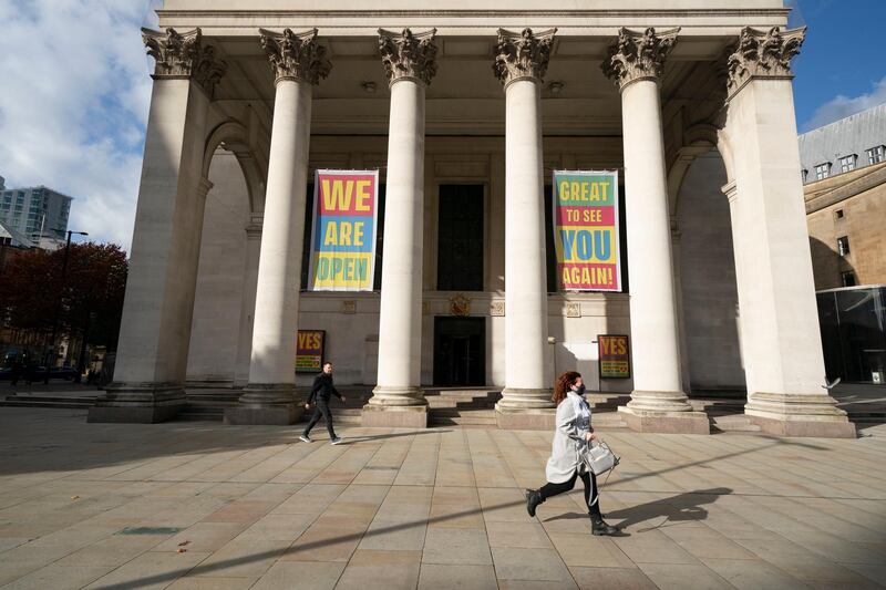 People pass Manchester Central Library. AP Photo