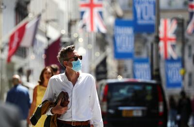 FILE PHOTO: A shopper wears a face mask in Old Bond Street, amid the coronavirus disease (COVID-19) outbreak, in London, Britain, July 18, 2020. REUTERS/Simon Dawson/File Photo