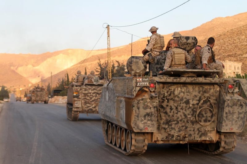 Lebanese army's armoured personal carriers (APC) drive to the entrance of the town of Arsal in the Bekaa valley by the Syrian border on August 2, 2014 as they arrive to secure the area where gunmen killed four people, including two soldiers, after clashes erupted following the arrest of a Syrian accused of belonging to an Islamist group. AFP Photo

