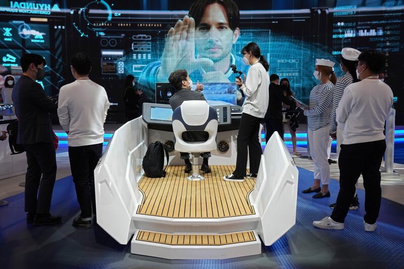 Attendees try out autonomous boat technology at the Hyundai Heavy Industries Group stand at CES 2022. AP Photo