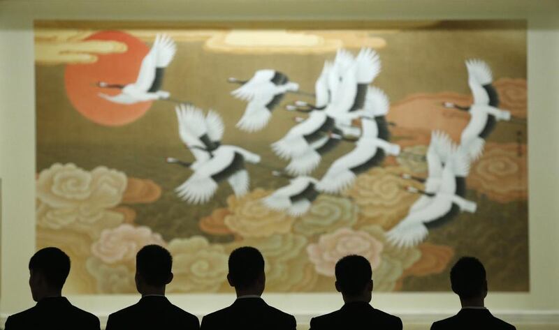 Security officers stand in front of a painting during the opening session of the Chinese People’s Political Consultative Conference inside the Great Hall of the People in Beijing on March 3, 2014. Kim Kyung-Hoon / Reuters