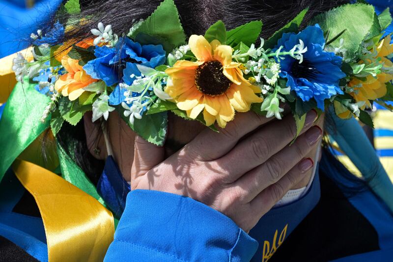 A member of the Ukrainian team cries during a moment of silence at the Zhangjiakou athletes village during the Beijing 2022 Winter Paralympic Games. AFP