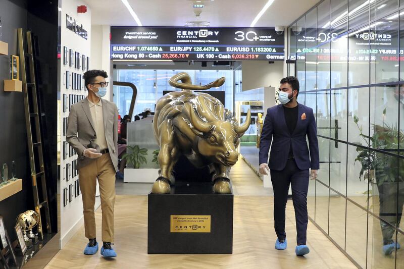 Dubai, United Arab Emirates - Reporter: N/A. Standalone. Covid-19/Coronavirus. Colleagues Shubham and Xieraili (L) chat at Century Financial. Employees are required to wear masks, gloves and over shoes. Thursday, August 27th, 2020. Dubai. Chris Whiteoak / The National