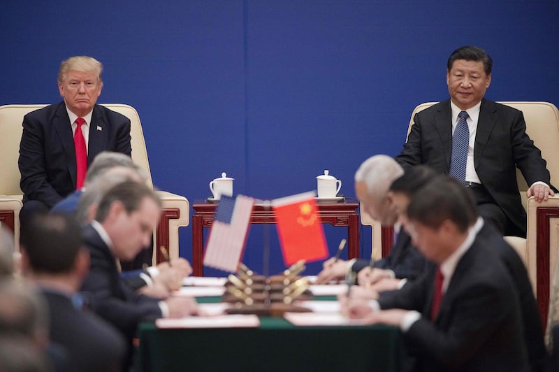(FILES) This file photo taken on November 9, 2017 shows US President Donald Trump (L) and China's President Xi Jinping attending a business leaders event inside the Great Hall of the People in Beijing.  From remote Himalayan valleys to small tropical islands and tense Western capitals, an increasingly assertive China is taking on conflicts around the world like never before as the United States retreats.
 - TO GO WITH AFP STORY CHINA-POLITICS-DIPLOMACY,FOCUS BY JING XUAN TENG
 / AFP / Nicolas ASFOURI / TO GO WITH AFP STORY CHINA-POLITICS-DIPLOMACY,FOCUS BY JING XUAN TENG

