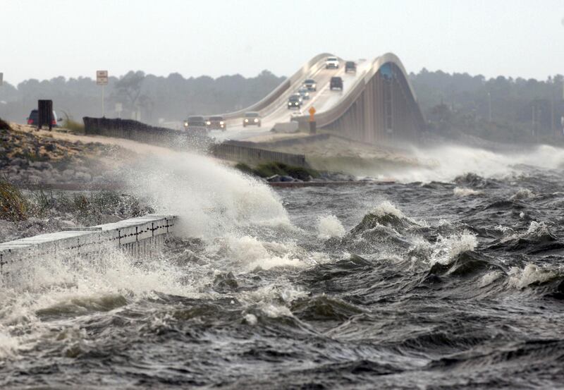 In this Tuesday, August 28, 2012 file photo, waves from the Santa Rosa Sound crash over the Navarre Beach causeway in Navarre, Florida, as Isaac approaches the Gulf Coast. The National Hurricane Center warns that the worst damage from 2017's Hurricane Irma could be from storm surge that could top 12 feet high in some areas of the Florida coast. Nick Tomecek / Northwest Florida Daily News via AP