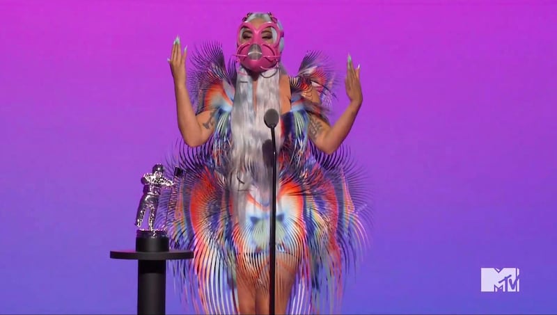 Lady Gaga, in a fringed Iris van Herpen dress and pink mask, accepts the award for Best Collaboration during the MTV Video Music Awards. AP