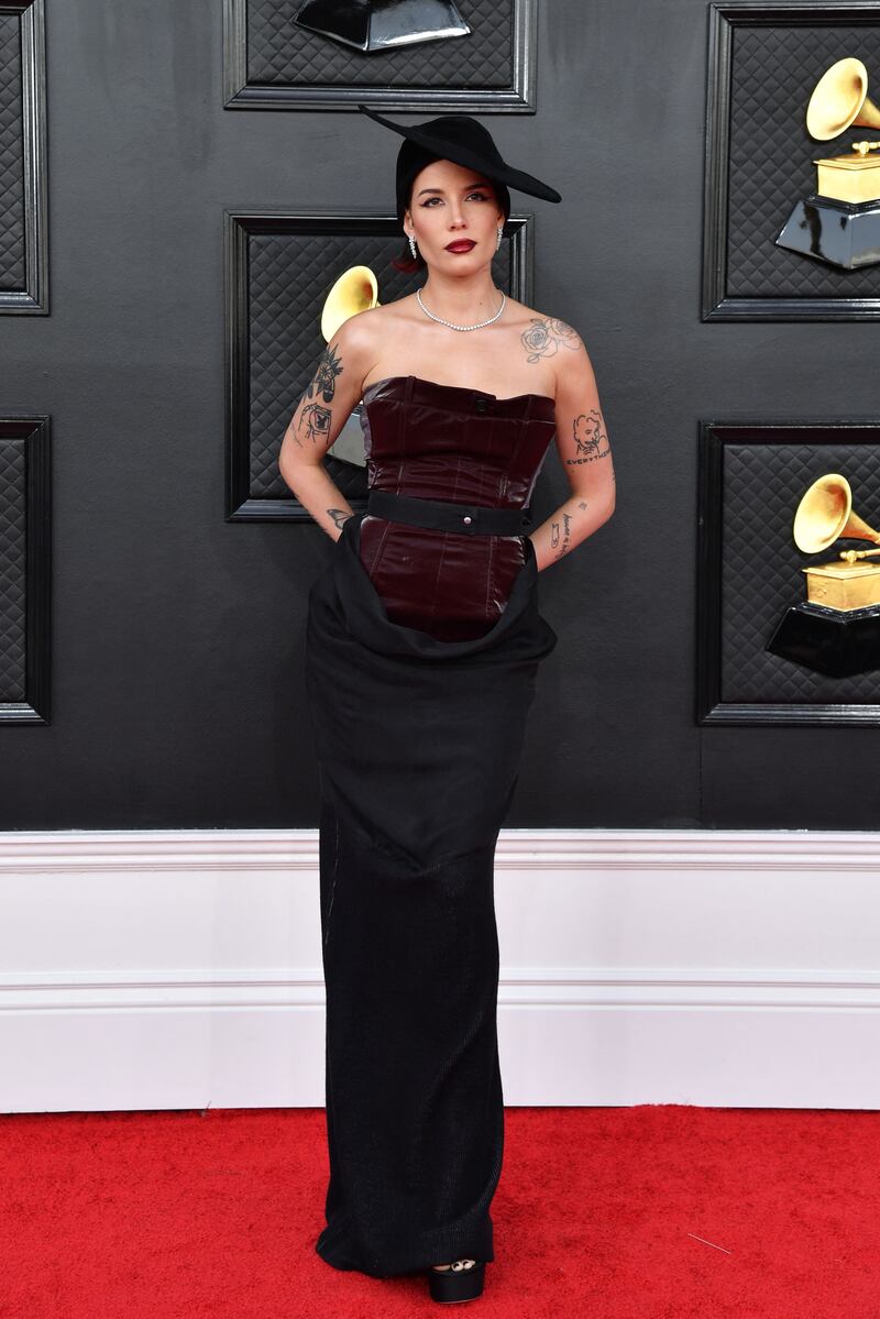 Halsey, wearing a bodiced black and burgundy dress. AFP