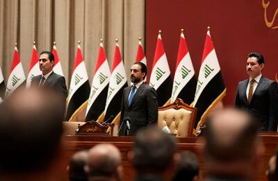Members of parliament attend a session with the new government in Baghdad, Iraq. AP