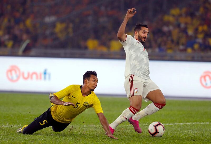 Malaysia's Adam Nor Azlin, left, fights for the ball with UAE's Ali Ahmed Mabkhout. AP