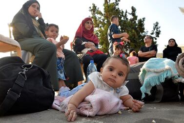 Syrian refugees gather as they prepare to leave Beirut, Lebanon, for Syria in September. Many newborns are unregistered and, without documentation, do not have access to healthcare. Wael Hamzah/EPA