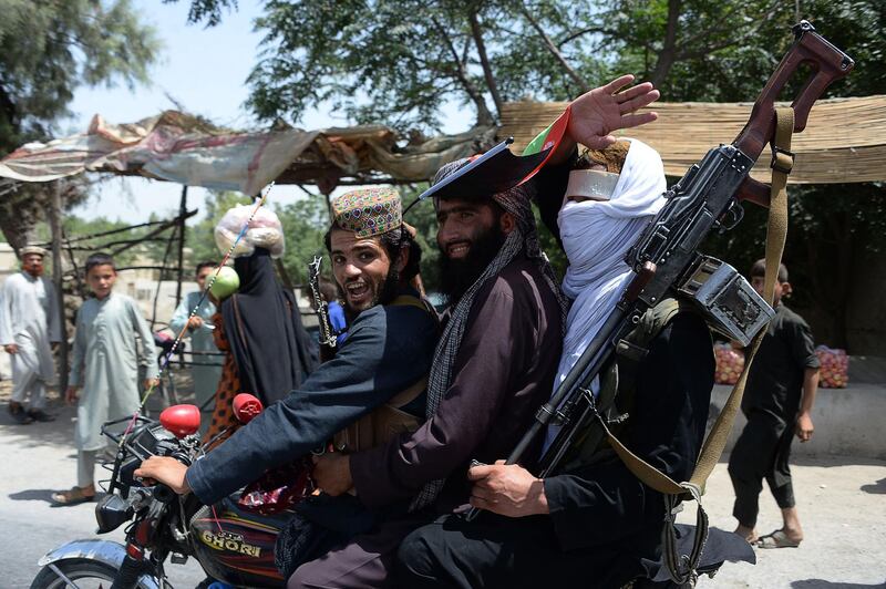 (FILES) In this file photo taken on June 16, 2018, Afghan Taliban militants ride a motorbike as they took to the street to celebrate ceasefire on the second day of Eid in the outskirts of Jalalabad. The Taliban have offered a brief ceasefire to their US counterparts in Doha, two insurgent sources said on January 16, a move which could allow the resumption of talks seeking a deal for Washington to withdraw troops from Afghanistan. / AFP / NOORULLAH SHIRZADA
