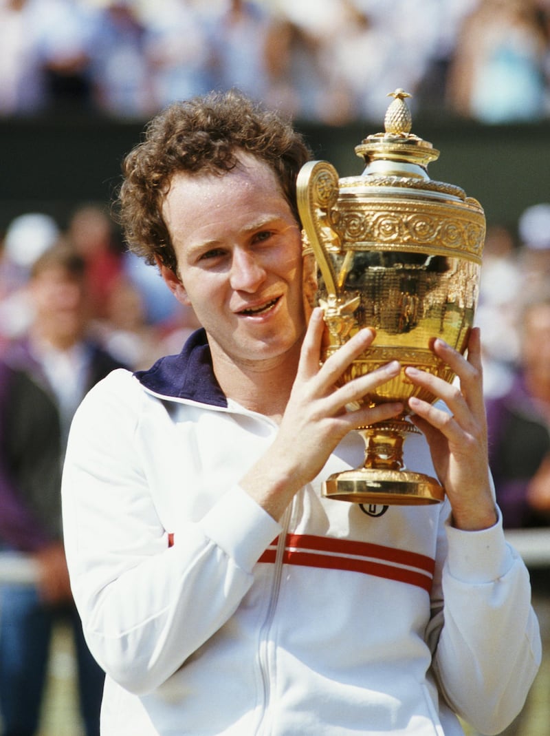 John McEnroe of the United States holds aloft the championship trophy after defeating Jimmy Connors to win the Men's Singles Final match at the Wimbledon Lawn Tennis Championship on 8 July 1984 at the All England Lawn Tennis and Croquet Club in Wimbledon in London, England. (Photo byTrevor Jones/Getty Images)
