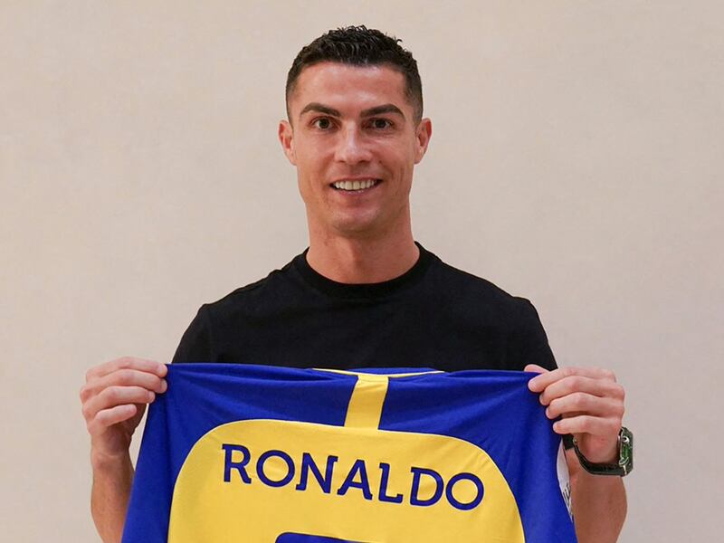Cristiano Ronaldo poses with his new number seven Al Nassr jersey in Madrid on December 30, 2022 upon signing for the Saudi Arabian club. AFP