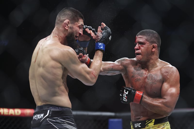 Gilbert Burns punches Khamzat Chimaev during their welterweight bout at UFC 273. Getty
