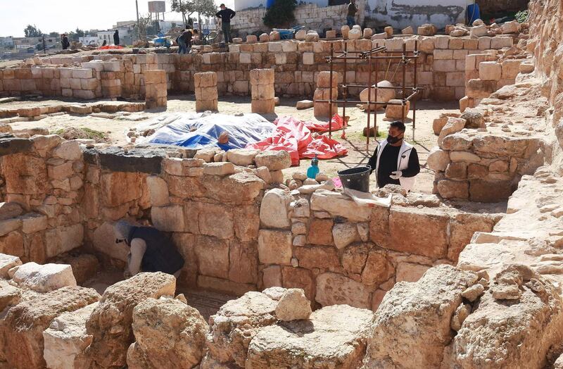 Workers restore a stone wall at the Byzantine church complex at Rihab, Jordan, which dates back almost 1,500 years. AFP