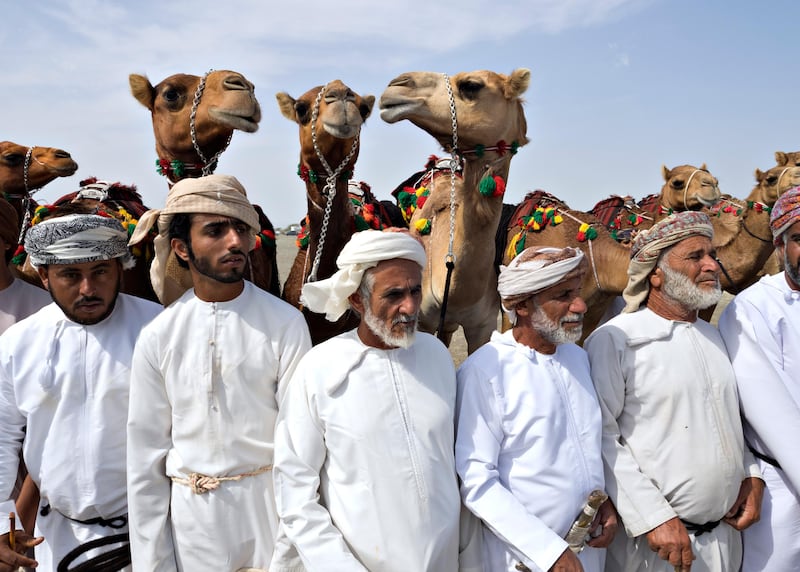 SAHAM, OMAN - February 11, 2017 - Men watch other tribal members sing poetry during a tribal celebration hosted by the Al Badi tribe in Saham, Oman February 11, 2017. Omani poetry is often about camels, landscape and love. (Photo by Jeff Topping/For The National) *** Local Caption ***  JT021-0211-OMAN TRIBE_2111864.JPG