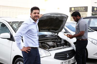 DUBAI , UNITED ARAB EMIRATES – Nov 29 , 2016 : Imad Hammad , founder and CEO of CarSwitch.com at the Swiss Tower in Jumeirah Lake Towers in Dubai. One of the car mechanic ( right ) checking the car at the Swiss Tower. ( Pawan Singh / The National ) For Business. Story by Gillian Duncan . ID No - 63914 *** Local Caption ***  PS2911- IMAD HAMMAD01.jpg