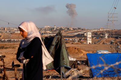 Smoke rises following an Israeli air strike on buildings near the wall separating Egypt and Rafah in southern Gaza. AP