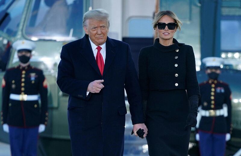 (FILES) In this file photo taken on January 20, 2021 outgoing US President Donald Trump and First Lady Melania Trump descend Marine One at Joint Base Andrews in Maryland. Donald Trump and his wife, Melania, were vaccinated against the coronavirus in January before leaving the White House, an advisor to the former president said on March 1, 2021. / AFP / ALEX EDELMAN
