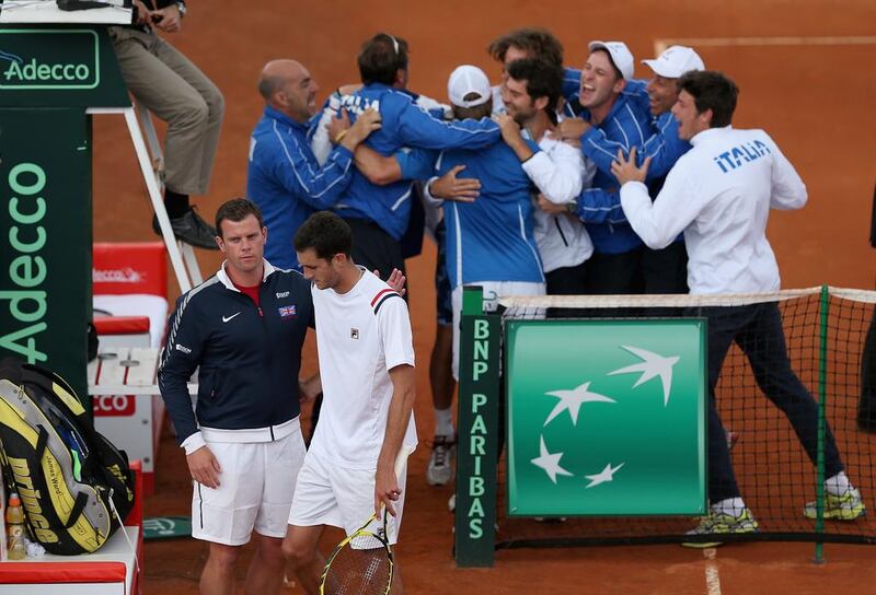 James Ward of Great Britain is consoled by his team captain Leon Smith after losing the fifth and decisive rubber to Andreas Seppi of Italy during the Davis Cup World Group quarter-final match between Italy and Great Britain at Tennis Club Napoli on Sunday in Naples, Italy. Clive Brunskill / Getty Images / April 6, 2014 